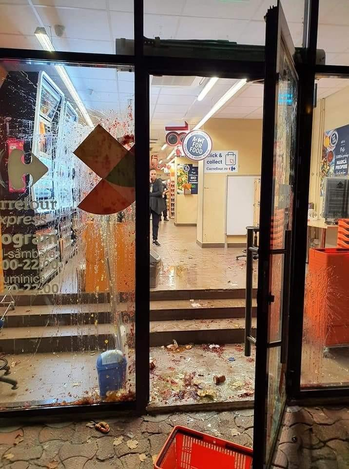 Prins la furat, a spart geamurile magazinului